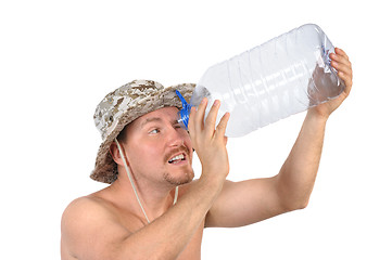 Image showing young man looking into empty bottle