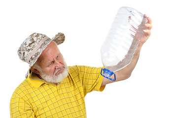 Image showing senior man looking into empty bottle