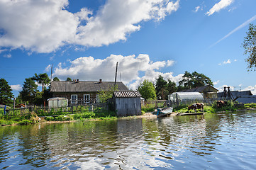 Image showing Russian wooden houses at river bank