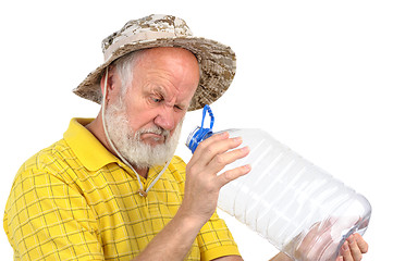 Image showing senior man looking into empty bottle