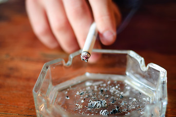 Image showing hand with cigarette and ashtray