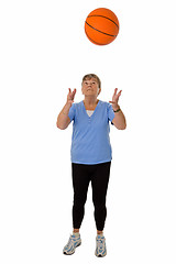 Image showing Senior woman throwing basketball