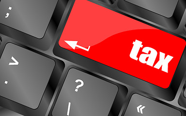 Image showing tax word on laptop keyboard key, business concept,