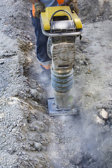 Image showing Worker uses compactor