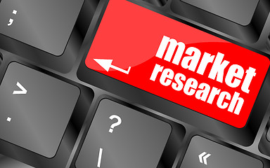 Image showing key with market research text on laptop keyboard, business concept