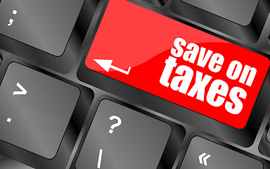 Image showing save on taxes word on laptop keyboard key, business concept