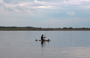 Image showing Surfer and fisherman simultaneously