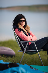 Image showing Woman sitting in chair at campsite