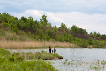 Image showing Family fishing on a lake