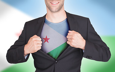 Image showing Businessman opening suit to reveal shirt with flag