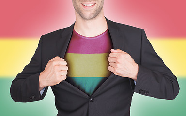 Image showing Businessman opening suit to reveal shirt with flag