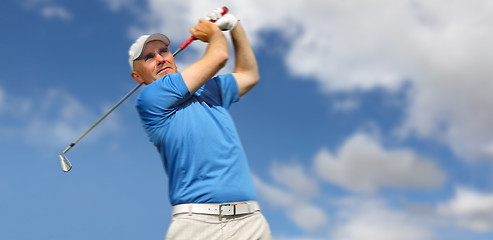 Image showing golfer shooting a golf ball