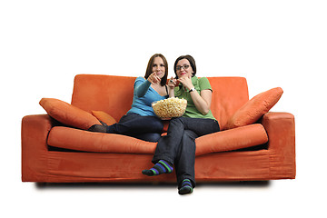 Image showing female friends eating popcorn and watching tv at home