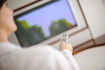 Image showing young woman watching tv at home