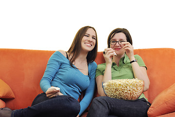 Image showing female friends eating popcorn and watching tv at home