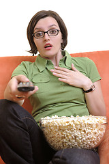 Image showing young woman eat popcorn and watching tv