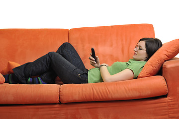 Image showing happy young woman relax on orange sofa