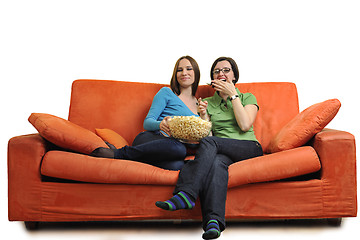 Image showing female friends eating popcorn and watching tv at home