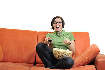 Image showing young woman eat popcorn and watching tv