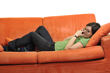 Image showing happy young woman relax on orange sofa