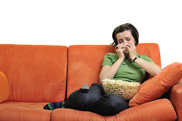 Image showing young woman eat popcorn and watching tv