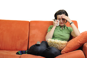 Image showing young woman eat popcorn and watching tv