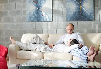 Image showing young couple using tablet computer at home