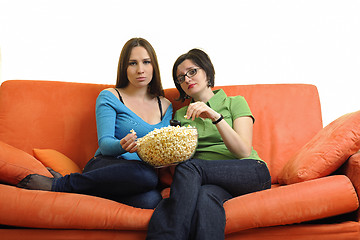 Image showing female friends eating popcorn and watching tv at home