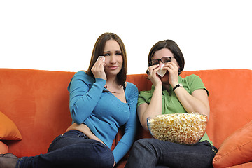 Image showing female friends eating popcorn and watching tv at home