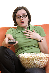 Image showing young woman eat popcorn and watching tv