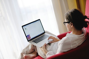 Image showing woman using a laptop computer at home