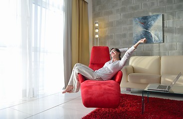 Image showing happy young woman relax at home on sofa