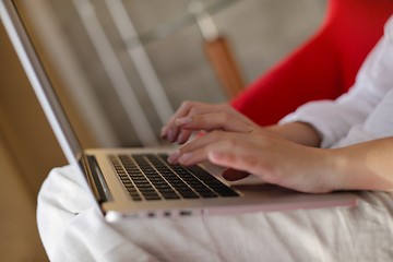 Image showing woman using a laptop computer at home