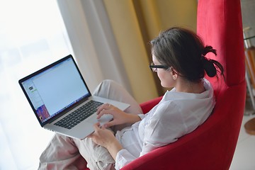 Image showing woman using a laptop computer at home