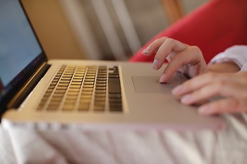 Image showing woman using a laptop computer at home