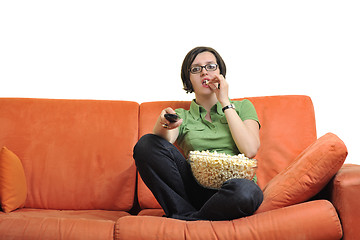 Image showing young woman eat popcorn and watching tv