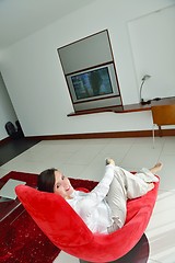 Image showing young woman watching tv at home