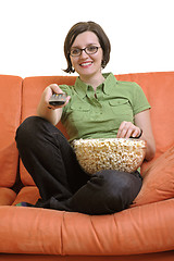 Image showing young woman eat popcorn and watching tv