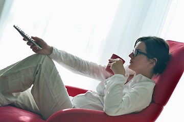 Image showing young woman watching tv at home