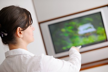 Image showing young woman watching tv at home