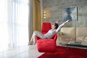 Image showing happy young woman relax at home on sofa