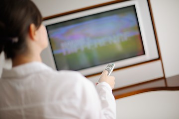 Image showing young woman watching tv at home