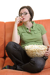 Image showing young woman eat popcorn and watching tv