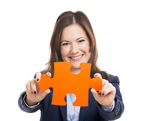 Image showing Business woman holding a puzzle piece