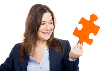 Image showing Business woman holding a puzzle piece