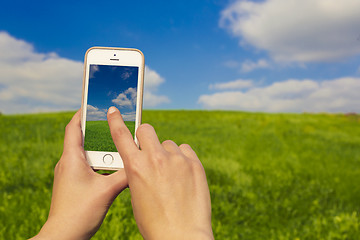 Image showing Taking pictures with a cellphone