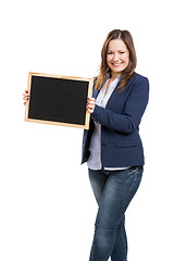 Image showing Business woman holding a shalkboard