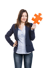 Image showing Business woman holding a puzzle piece