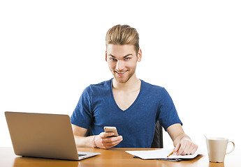 Image showing Young man sending text messages