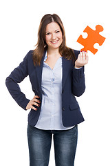Image showing Business woman holding a puzzle piece